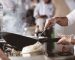 A closeup shot of a chef cooking with a blurred background